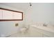 Bathroom features a window, toilet and marble countertop sink at 493 N Avon Ave, Avon, IN 46123