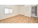 A sunlit bedroom featuring light wood-look floors, a window, and white walls at 493 N Avon Ave, Avon, IN 46123