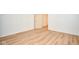 An empty bedroom with wood-look flooring, light walls, and white trim at 493 N Avon Ave, Avon, IN 46123