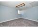 Cozy bedroom features light blue walls, plush carpeting, and natural light from the window at 493 N Avon Ave, Avon, IN 46123