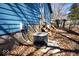 Exterior view of the blue-sided house showing the HVAC unit and backyard access at 493 N Avon Ave, Avon, IN 46123