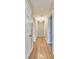 Long hallway with hardwood floors and modern lighting connecting bedrooms and living areas at 493 N Avon Ave, Avon, IN 46123