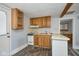 Compact kitchen featuring wooden cabinets, a range, sink, and breakfast bar area at 493 N Avon Ave, Avon, IN 46123