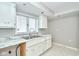 The kitchen features marble counters, white cabinets, stainless sink and large window at 493 N Avon Ave, Avon, IN 46123