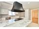 Bright kitchen with marble countertops, white cabinets, and modern appliances at 493 N Avon Ave, Avon, IN 46123