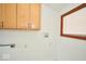 Clean, functional laundry area with upper cabinets and window for natural light at 493 N Avon Ave, Avon, IN 46123