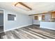 Open living room featuring modern gray flooring, neutral blue walls, and kitchen access, flooded with light at 493 N Avon Ave, Avon, IN 46123