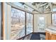 Sunroom with large windows offering backyard views and access to an outdoor deck at 493 N Avon Ave, Avon, IN 46123