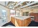 Bright sunroom with jacuzzi, a ceiling fan, and brick accent wall, perfect for relaxation at 493 N Avon Ave, Avon, IN 46123