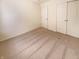 Bedroom featuring neutral carpet, white walls, one standard closet and one sliding door closet at 4943 Dunlin Dr, Indianapolis, IN 46235