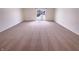Empty bedroom with sliding glass doors, ample natural light and neutral carpeting at 4943 Dunlin Dr, Indianapolis, IN 46235