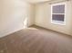 Bright bedroom featuring neutral carpet, white walls, and a window with exterior view at 4943 Dunlin Dr, Indianapolis, IN 46235