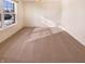 Empty dining room with neutral carpeting, a large window, and modern lighting at 4943 Dunlin Dr, Indianapolis, IN 46235