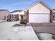 Charming single-Gathering home featuring a two-car garage and brick accents on a snow-covered lot at 4943 Dunlin Dr, Indianapolis, IN 46235