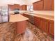 Modern kitchen with stainless steel appliances, rich wood cabinets, and a functional center island at 4943 Dunlin Dr, Indianapolis, IN 46235