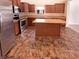 Well-equipped kitchen with stainless steel appliances, abundant wood cabinets, and a functional center island at 4943 Dunlin Dr, Indianapolis, IN 46235