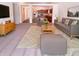 Bright living room showcasing modern furniture, plush rug and open concept to the kitchen at 4943 Dunlin Dr, Indianapolis, IN 46235