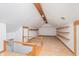 Attic space featuring wooden beams, finished floor, built-in shelves, and a staircase at 5004 Boardwalk Pl, Indianapolis, IN 46220