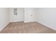 Neutral bedroom featuring wall-to-wall carpeting, a window for natural light, and a paneled interior door at 5004 Boardwalk Pl, Indianapolis, IN 46220