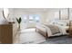 Serene bedroom featuring large windows with a lake view, a comfortable king bed, and stylish decor at 5004 Boardwalk Pl, Indianapolis, IN 46220