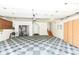 Spacious garage featuring black and white patterned flooring, cabinets, and staircase to upper level at 5004 Boardwalk Pl, Indianapolis, IN 46220