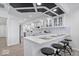 Modern kitchen featuring a breakfast bar, white cabinets, quartz countertops, and contemporary lighting fixtures at 5004 Boardwalk Pl, Indianapolis, IN 46220
