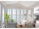 Bright sunroom with water views, a vaulted ceiling, floor to ceiling windows, and stylish furniture at 5004 Boardwalk Pl, Indianapolis, IN 46220