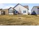 Backyard featuring green space, deck, sunroom, and a charming exterior view at 553 Farnham Dr, Westfield, IN 46074