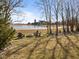 Backyard view featuring an outdoor firepit and Adirondack chairs overlooking the nearby pond at 553 Farnham Dr, Westfield, IN 46074
