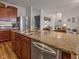 Open kitchen and living area featuring granite counters, stainless steel appliances, and wood cabinets at 553 Farnham Dr, Westfield, IN 46074