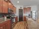 A kitchen featuring stainless steel appliances, granite counters, and wood cabinets at 553 Farnham Dr, Westfield, IN 46074