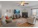 Inviting living room featuring a fireplace, large screen tv, ceiling fan and stylish decor at 553 Farnham Dr, Westfield, IN 46074