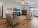 Cozy living room with a ceiling fan, fireplace, comfortable seating, and natural light from the outdoor view at 553 Farnham Dr, Westfield, IN 46074
