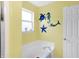 Bathroom featuring a tub, a window, and charming decorations at 5772 Jamestown Square Ln, Indianapolis, IN 46234