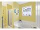 Bathroom showcasing a tub, a shower, and a window at 5772 Jamestown Square Ln, Indianapolis, IN 46234