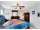 Bedroom features a ceiling fan, wood furniture, and colorful accents at 5772 Jamestown Square Ln, Indianapolis, IN 46234