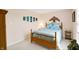 Cozy bedroom featuring a wooden bed frame, soothing wall decor, and plush carpet at 5772 Jamestown Square Ln, Indianapolis, IN 46234