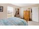Bright bedroom with hardwood furniture and a large window for natural lighting at 5772 Jamestown Square Ln, Indianapolis, IN 46234