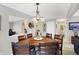 Inviting dining room with a wooden table, chandelier, and view into the kitchen at 5772 Jamestown Square Ln, Indianapolis, IN 46234