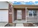 Inviting front porch features brick accents, a cozy seating area, and a charming entrance at 5772 Jamestown Square Ln, Indianapolis, IN 46234