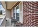 Relaxing front porch showcases outdoor seating, brick details, and a welcoming ambiance at 5772 Jamestown Square Ln, Indianapolis, IN 46234