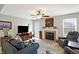 Living room featuring fireplace, large screen television and comfortable couches at 5772 Jamestown Square Ln, Indianapolis, IN 46234