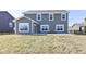 Exterior view of home featuring a patio area, well-maintained grass and yard, and large picture windows at 6199 N Caraway Dr, McCordsville, IN 46055