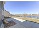 Backyard patio area overlooking well-maintained grass area, a black fence, and a scenic view of the lake at 6199 N Caraway Dr, McCordsville, IN 46055
