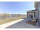 Backyard patio area overlooking well-maintained grass area, a black fence, and a scenic view of the lake at 6199 N Caraway Dr, McCordsville, IN 46055
