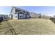 Large grass backyard with a black fence separating the yard from a lake view and neighborhood at 6199 N Caraway Dr, McCordsville, IN 46055