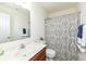 Bathroom with a wooden vanity, marble top, toilet, decorative shower curtain, and neutral-colored walls at 6199 N Caraway Dr, McCordsville, IN 46055