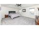 Serene bedroom featuring a tray ceiling, ceiling fan, and large windows with water views at 6199 N Caraway Dr, McCordsville, IN 46055