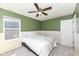 Bright bedroom featuring a ceiling fan, neutral carpet, and a window providing natural light at 6199 N Caraway Dr, McCordsville, IN 46055