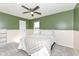 Bright bedroom featuring a ceiling fan, neutral carpet, and a window providing natural light and outside views at 6199 N Caraway Dr, McCordsville, IN 46055